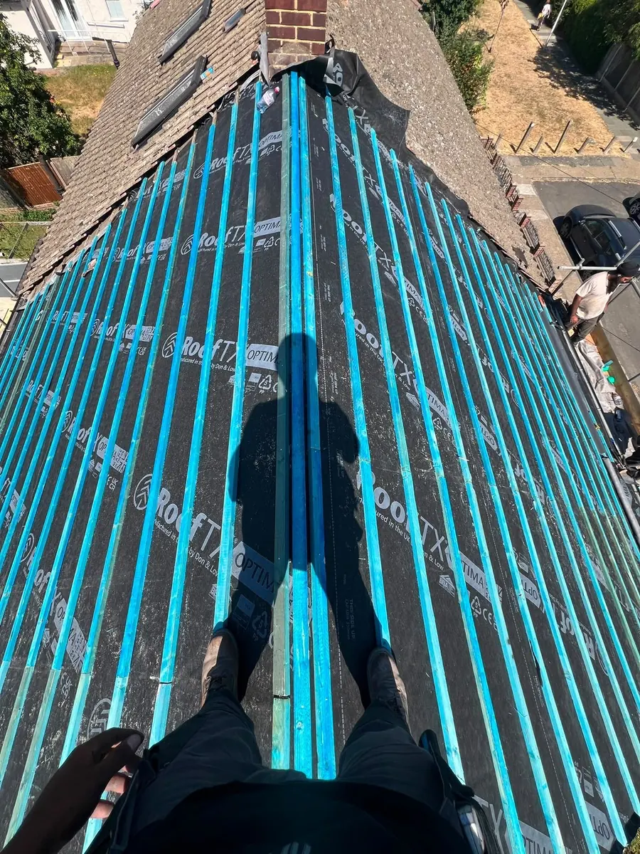Blue breathable membrane and battens on a stripped slope, Dawn Roofs Ltd