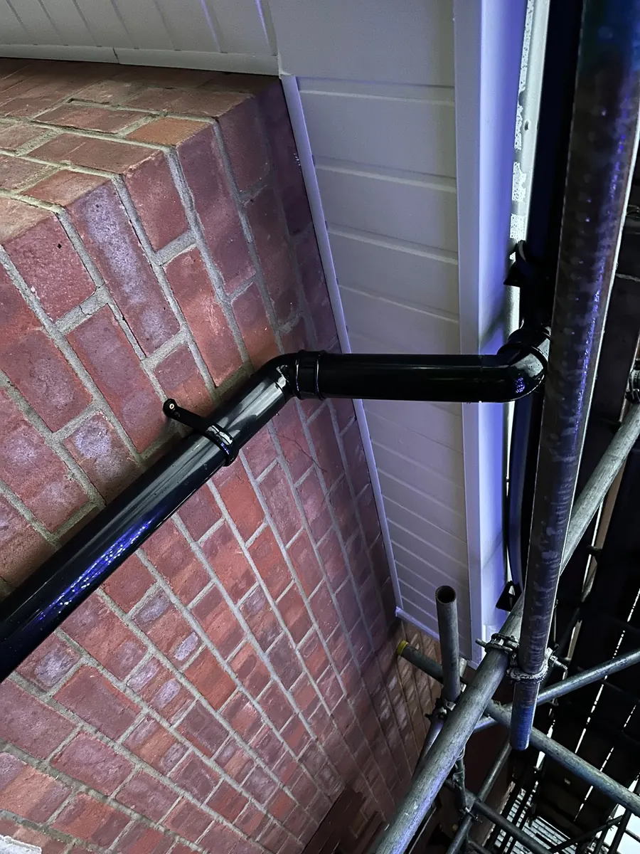 New downpipe fixed to a brick wall, Dawn Roofs Ltd