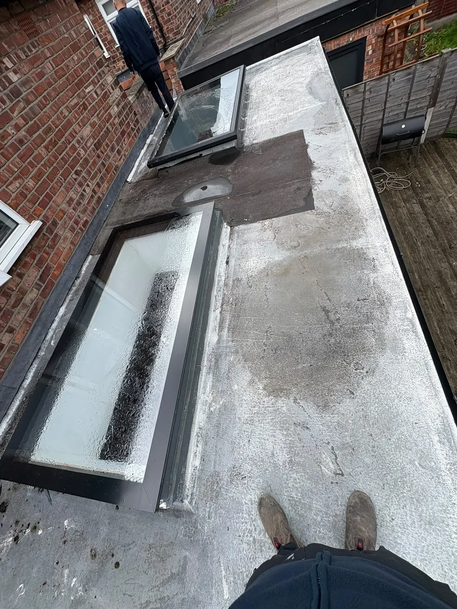 Worn flat roof before work, with a rooflight, Dawn Roofs Ltd
